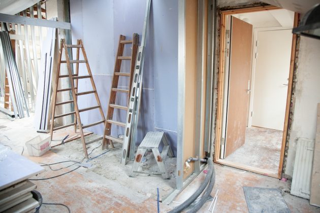 Wooden ladders and drywall panels at home renovation construction site