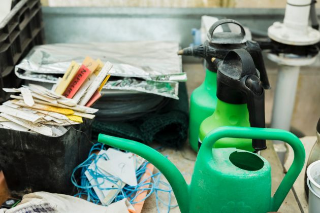 Gardening equipment and plastic bottles stored during commercial cleanout process