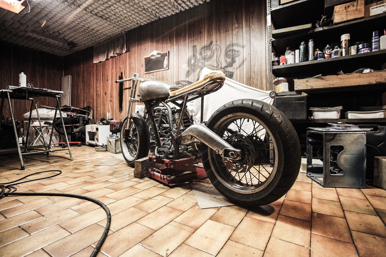 Disassembled motorcycle inside home garage undergoing garage cleanouts organization project