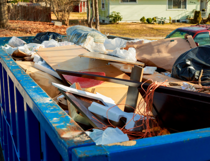 Large blue container filled with debris for construction waste removal