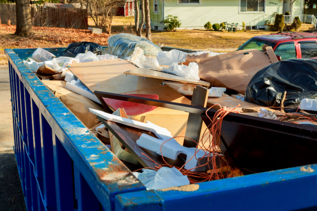 Large blue container filled with debris for construction waste removal